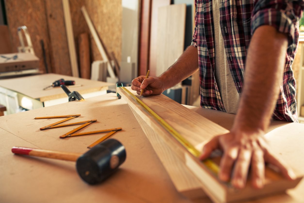 About Us 2 About Carpenter doing his job in carpentry workshop